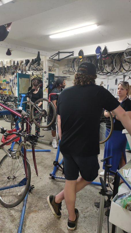 People chatting in a Access Bike workshop 