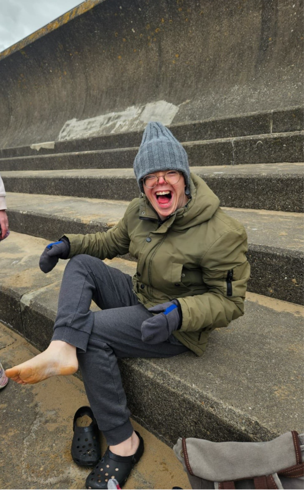 a participant is looking very happy on the beach